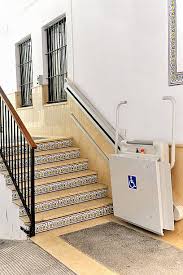 A platform lift folded up next to stairs